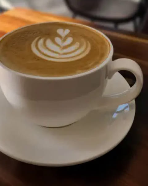 Latte with heart-shaped latte art at Cafe Time