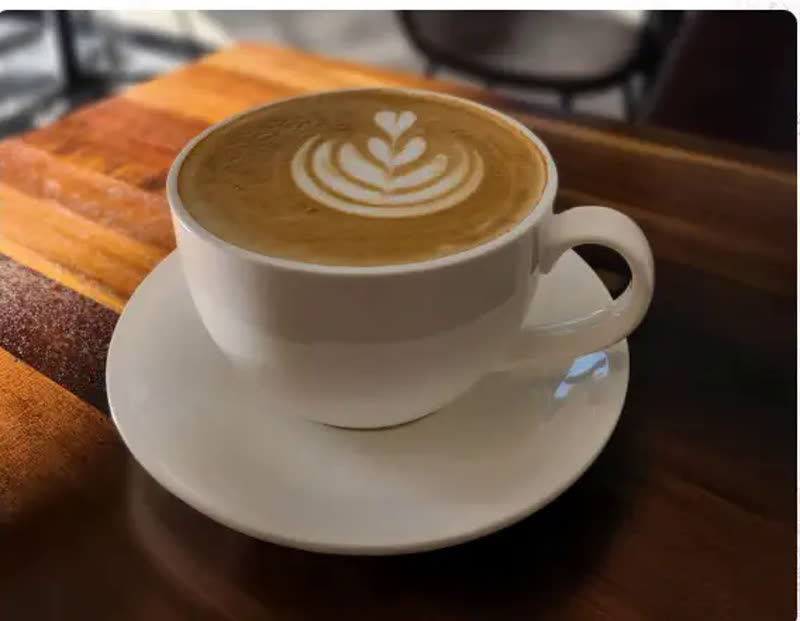 Latte with heart-shaped latte art at Cafe Time